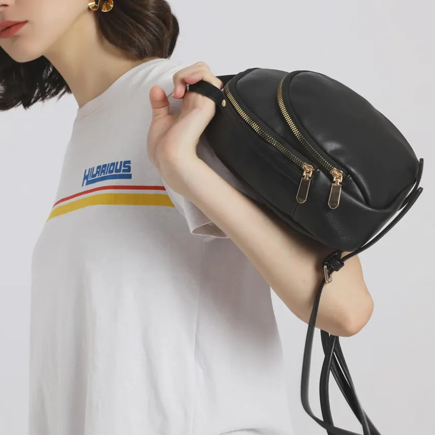 Solid Matte Black Curved Dome Mini Backpack With Dual Gold Tone Zipper Pulls, Short Curved Top Grip And Thin Metal Fitted Rear Support Straps