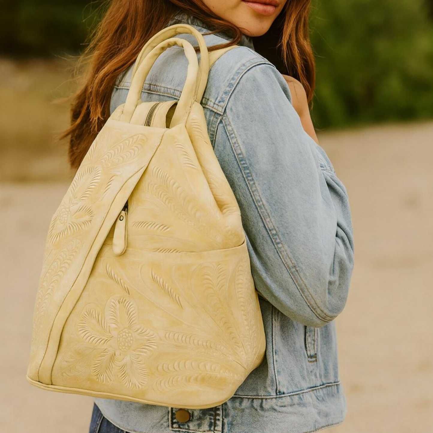 Pale Buttery Cream Embossed Floral Feather Convertible Carryall With Rounded Top Grip, Vertical Side Zipper Pocket And Integrated Rear Support Straps