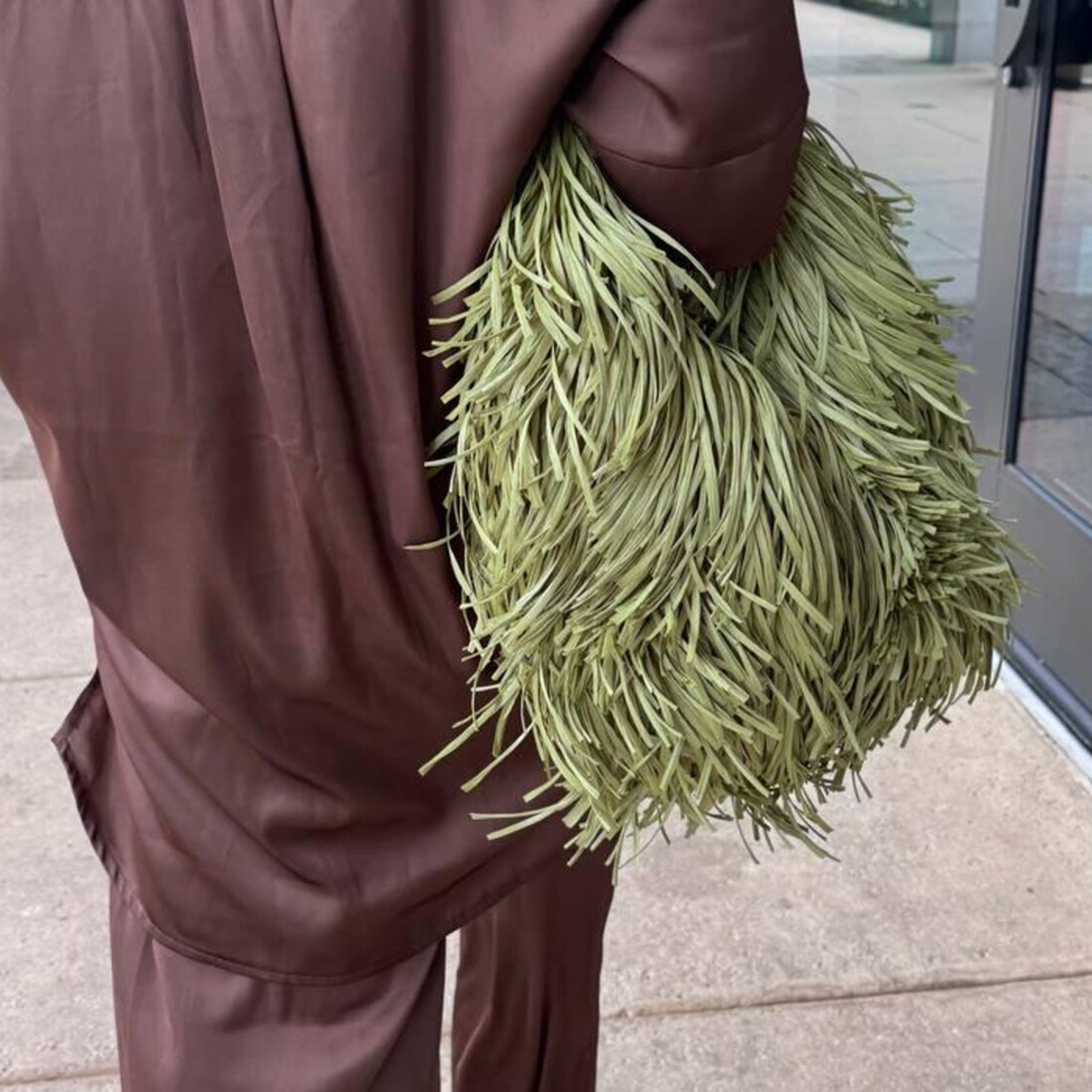 Muted Sage Green Full Fringe Covered Curved Hand Tote With Thick Braided Circular Grip Loop, Wide Open Spacious Inner Cavity And Flowing Layered Strand Detailing