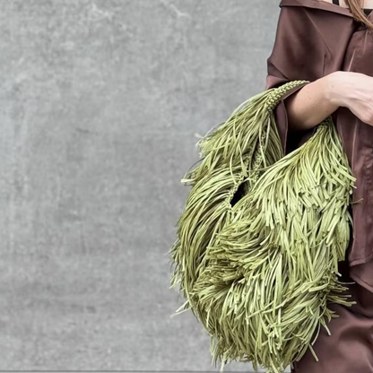Muted Sage Green Full Fringe Covered Curved Hand Tote With Thick Braided Circular Grip Loop, Wide Open Spacious Inner Cavity And Flowing Layered Strand Detailing