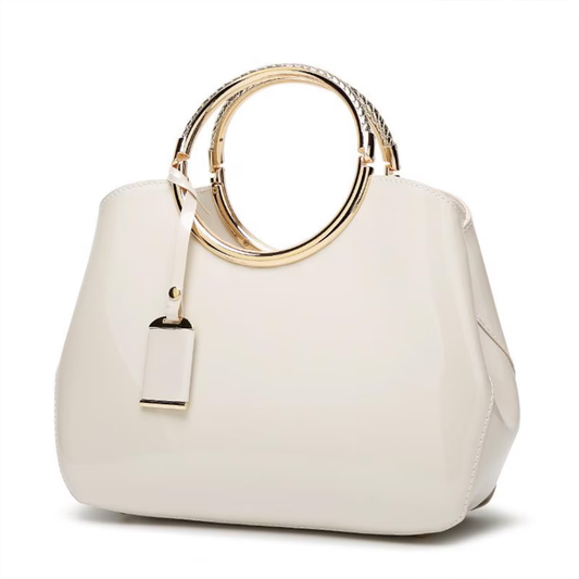 Cream Off-White Polished Trapezoid Carryall With Layered Embossed Golden Circular Hoop Handles, Metallic Trimmed Hanging Tag And Spacious Rounded Inner Compartment