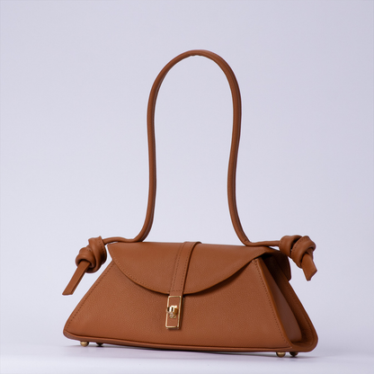 Warm Sienna Tan Trapezoid Elongated Shoulder Bag With Hand-Tied Knot Handle Ends, Curved Overlap Flap And Base Protective Metal Feet