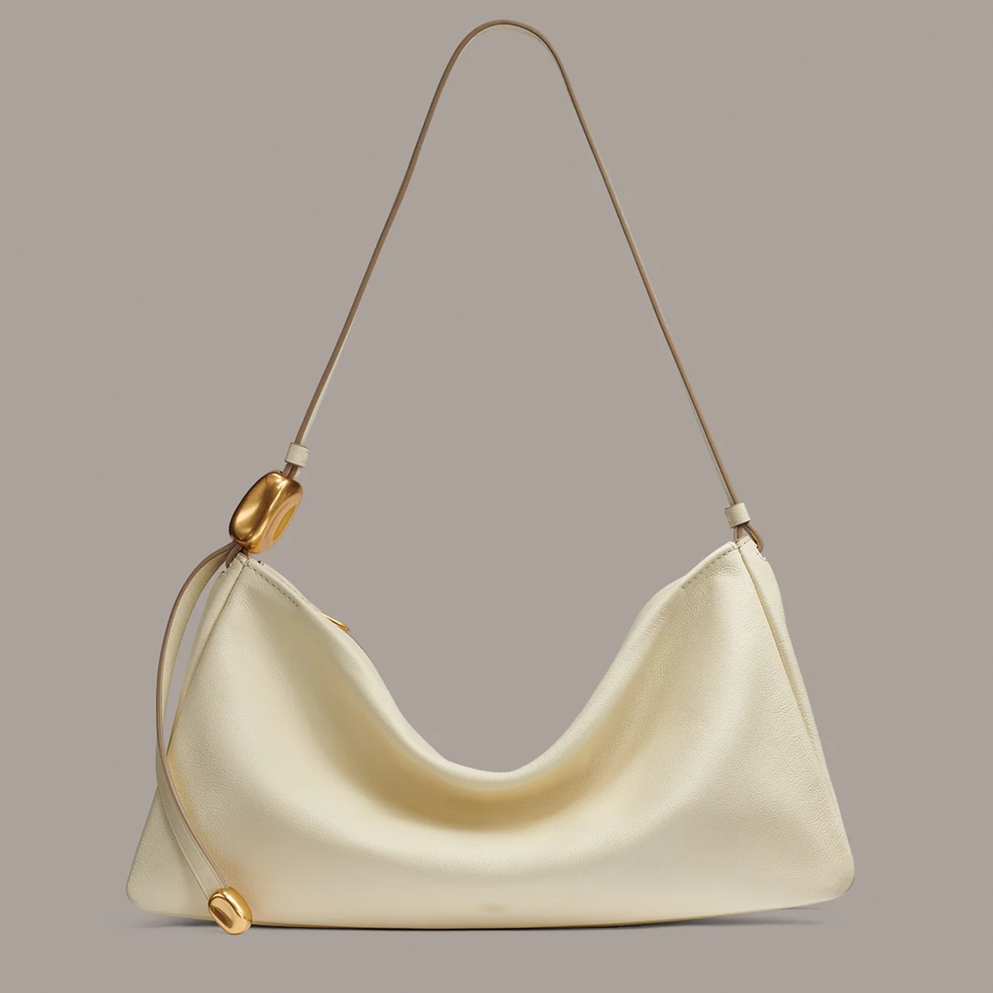 Creamy Ivory Draped Crescent Shoulder Bag With Slim Single Shoulder Strap, Pebble Shaped Gold Metallic Accents And Curved Central Dip Silhouette