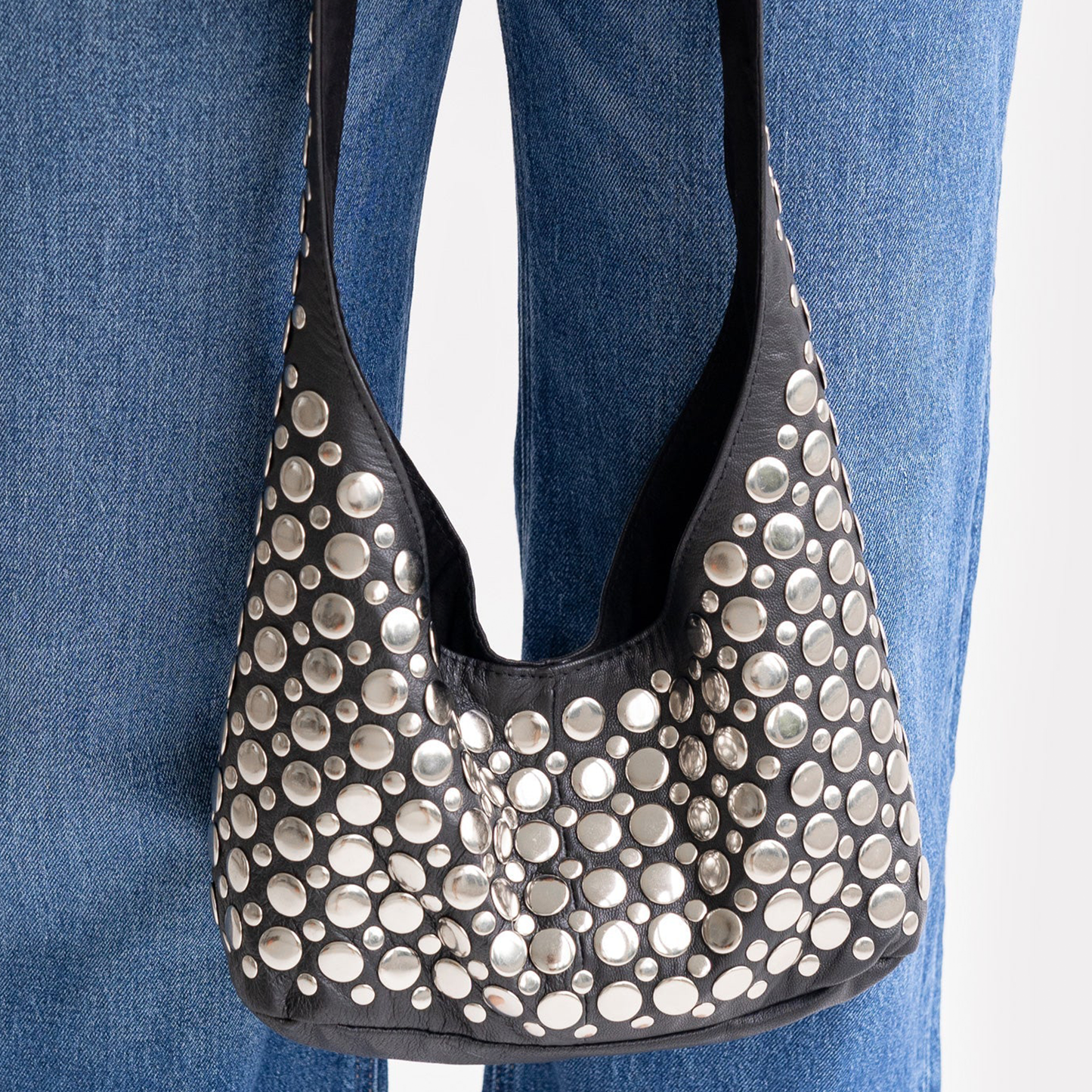 Jet Black Tapered Hobo Shoulder Bag With Scattered Multi-Size Silver Circular Disc Embellishments, Wide Integrated Single Shoulder Strap And Curved V-Shaped Top Opening