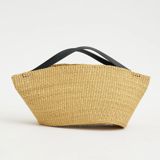 Natural Straw Asymmetrical Pinched Fan Shaped Tote With Smooth Curved Overhead Grip Strips, Wide Open Unsegmented Cavity And Soft Folded Base Silhouette