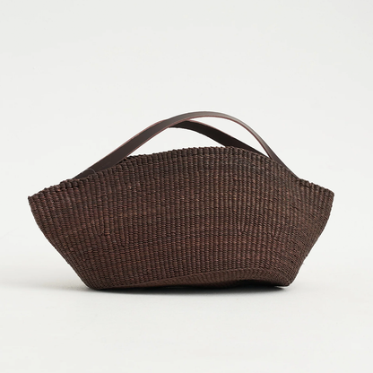 Natural Straw Asymmetrical Pinched Fan Shaped Tote With Smooth Curved Overhead Grip Strips, Wide Open Unsegmented Cavity And Soft Folded Base Silhouette