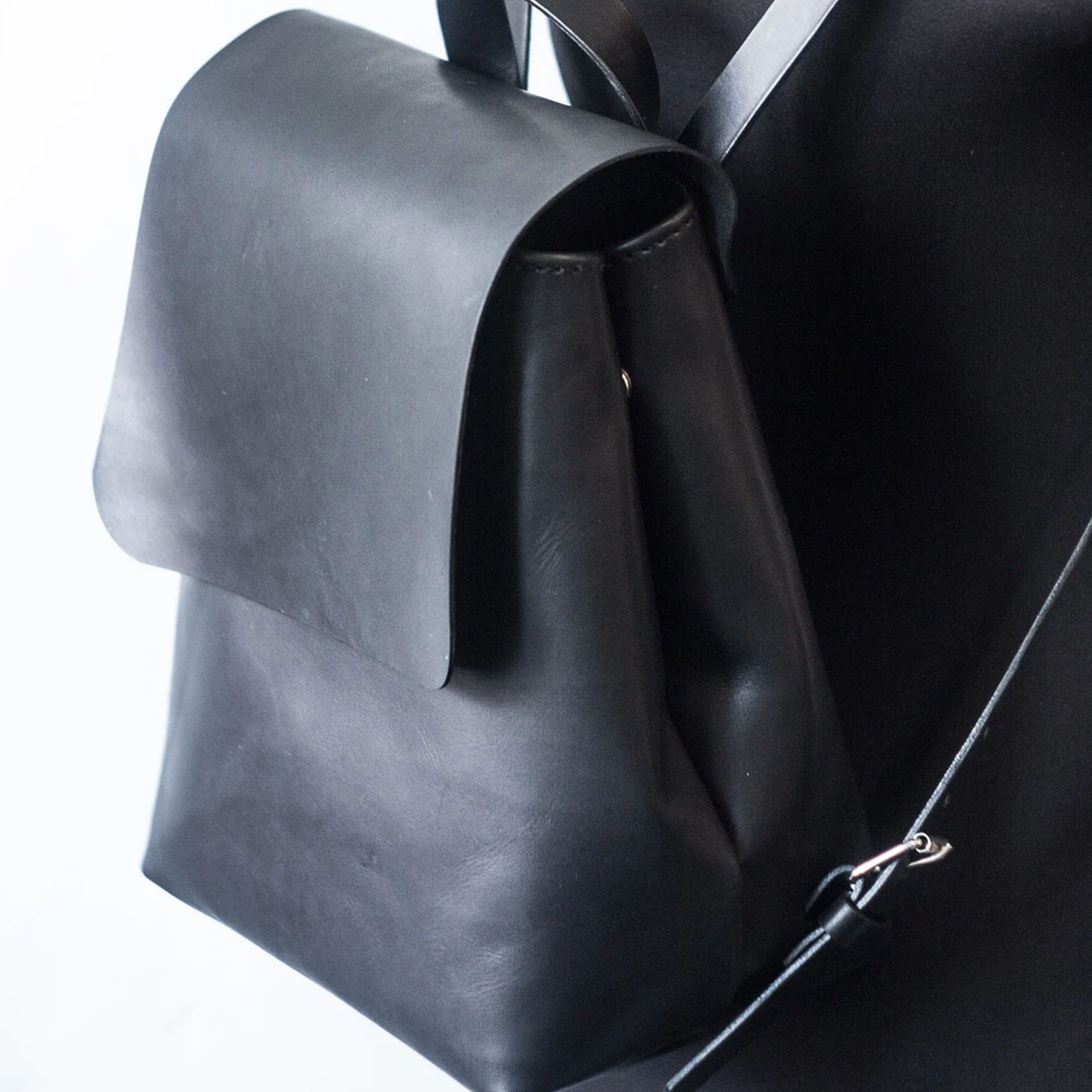 Jet Black Tapered Bucket Mini Rucksack With Wide Folded Front Flap, Curved Top Carry Loop And Stud Reinforced Rear Slip Pocket